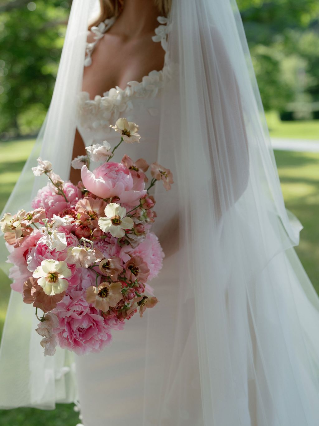 Image may contain Clothing Dress Fashion Formal Wear Gown Wedding Wedding Gown Flower and Flower Arrangement