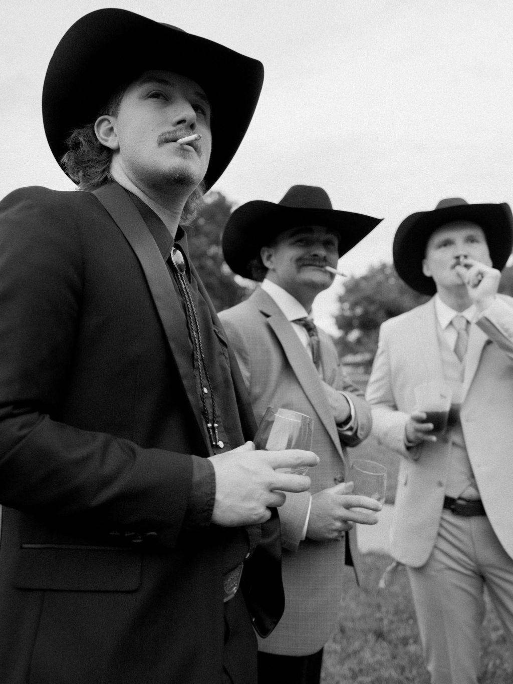 Image may contain Clothing Hat Formal Wear Suit Sun Hat Coat Adult Person Body Part Finger Hand Face and Head