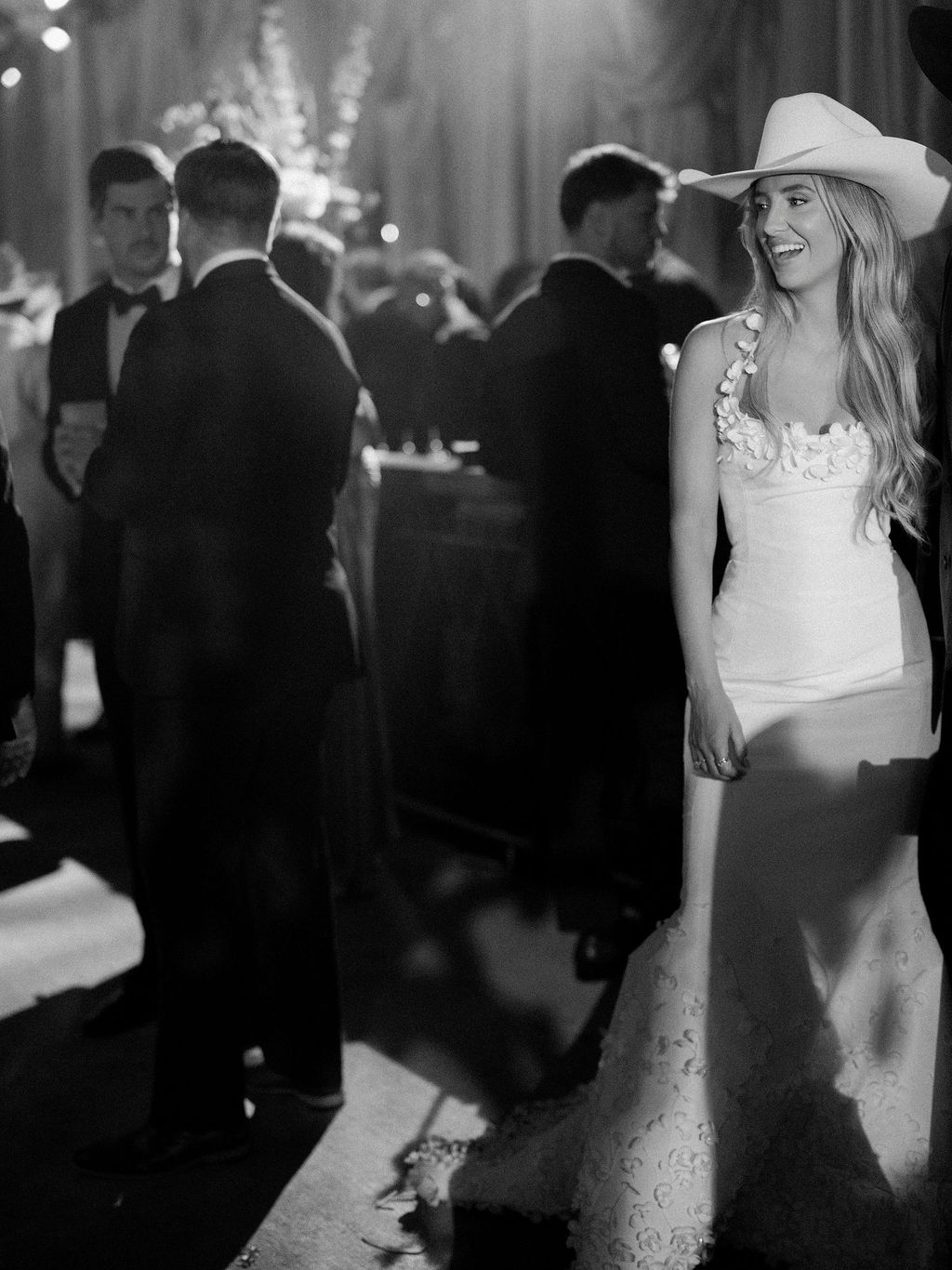 Image may contain Clothing Dress Formal Wear Hat Suit Back Body Part Person Fashion Adult Wedding and Gown