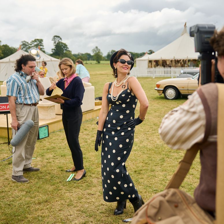 Image may contain: Annabel Scholey, Clothing, Dress, Person, Photobombing, Glove, Adult, Formal Wear, Face, Head, and Car