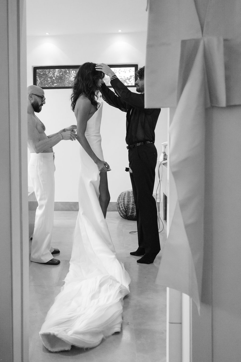 Image may contain Romain Gavras Clothing Dress Fashion Formal Wear Gown Wedding Wedding Gown Adult Person and Suit
