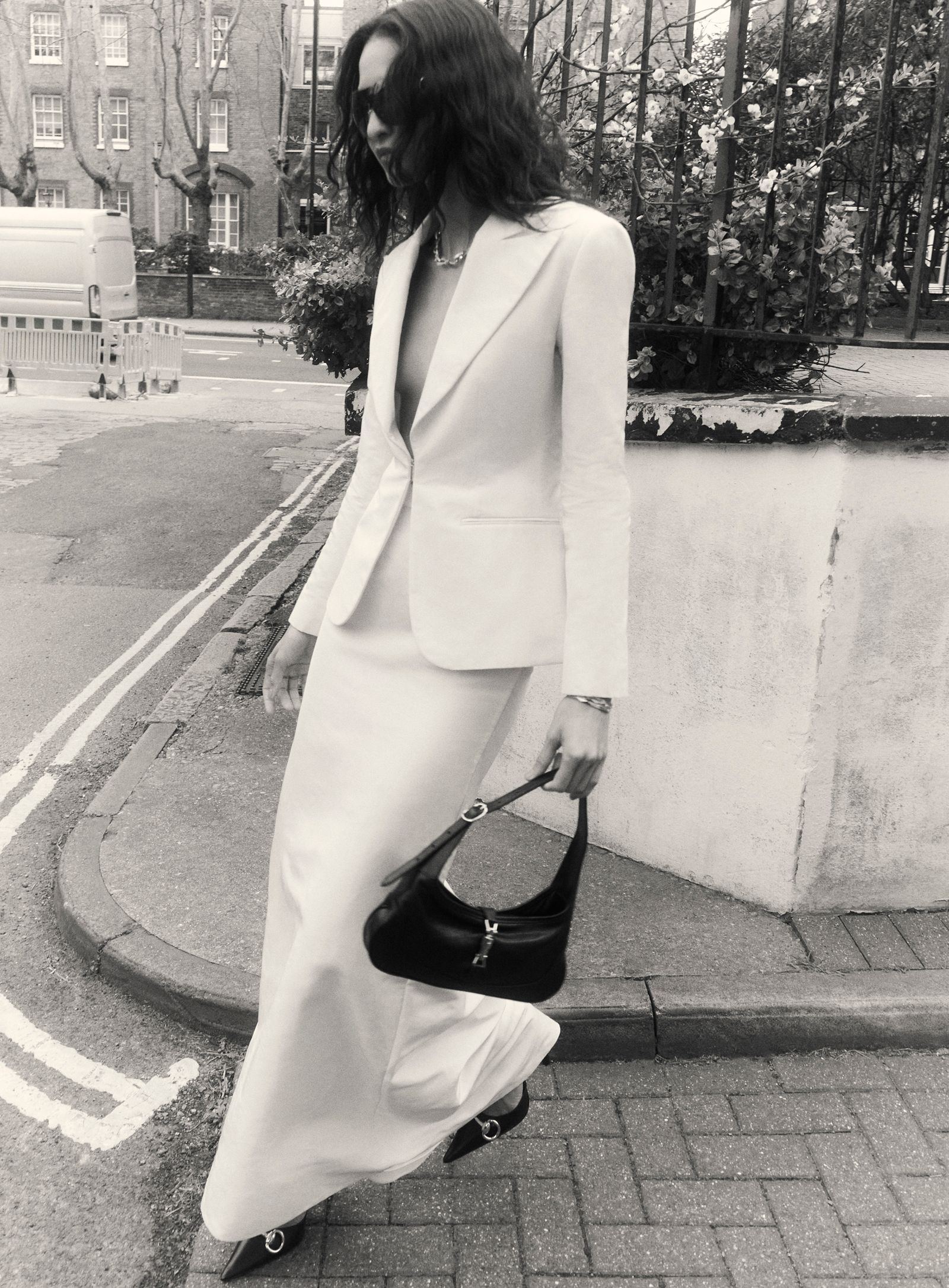 Image may contain Clothing Formal Wear Suit Accessories Bag Handbag Blazer Coat Jacket Purse Footwear and Shoe