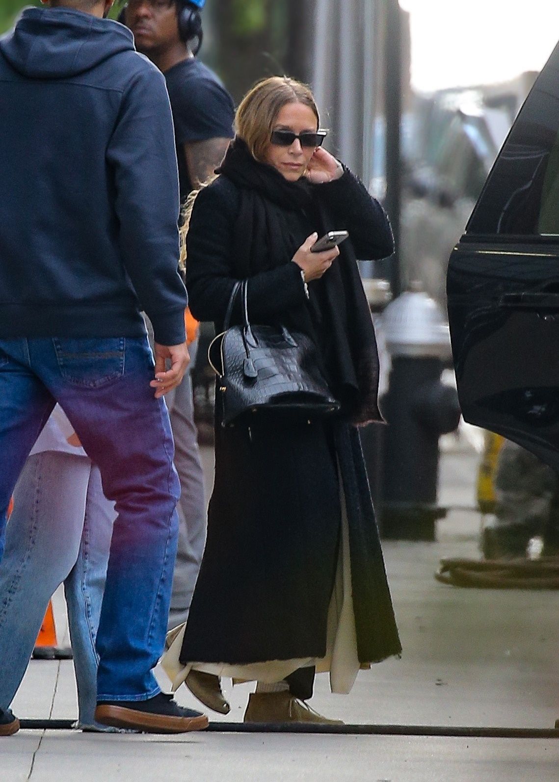 Image may contain MaryKate Olsen Adult Person Clothing Pants Accessories Bag Handbag Pedestrian Glasses and Jeans