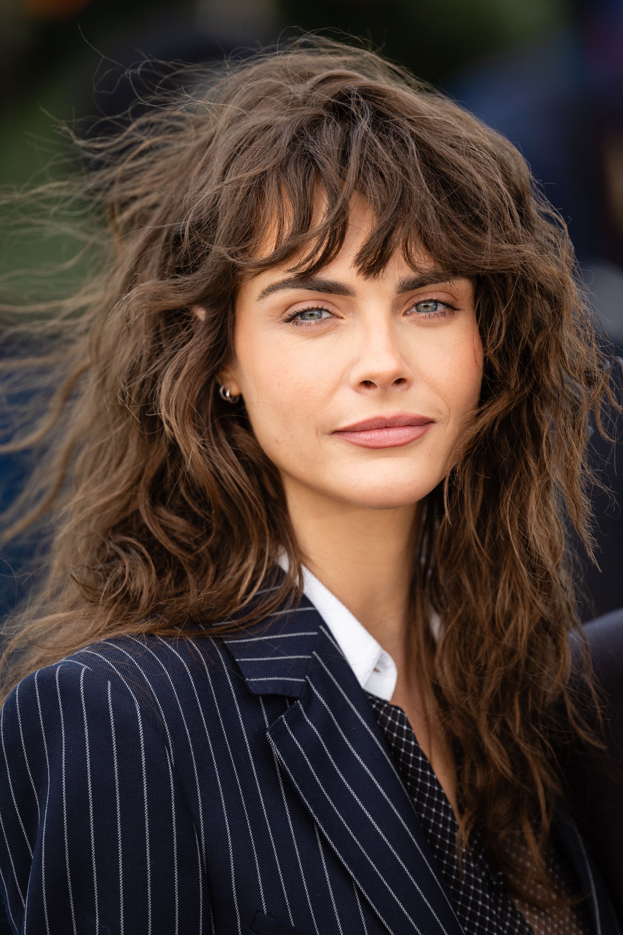 Image may contain Cara Delevingne Face Head Person Photography Portrait Blonde Hair Adult Formal Wear and Clothing