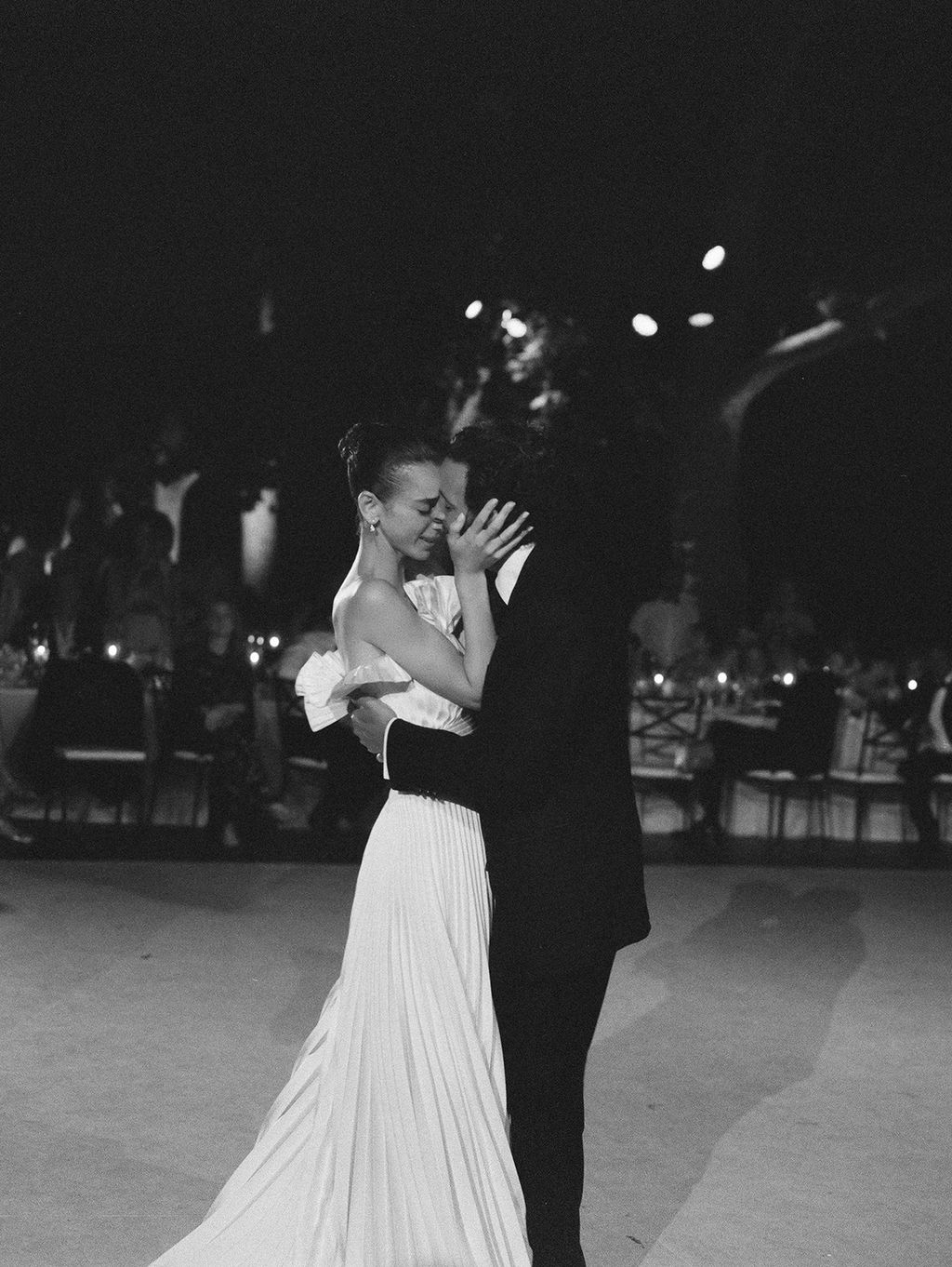 Image may contain Clothing Formal Wear Suit Lighting Face Head Person Photography Portrait Dress and Dancing