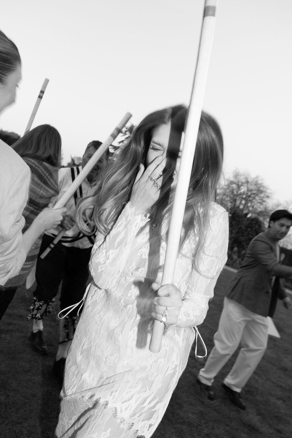 Image may contain Face Head Person Photography Portrait Body Part Finger Hand Adult Walking Sword and Weapon