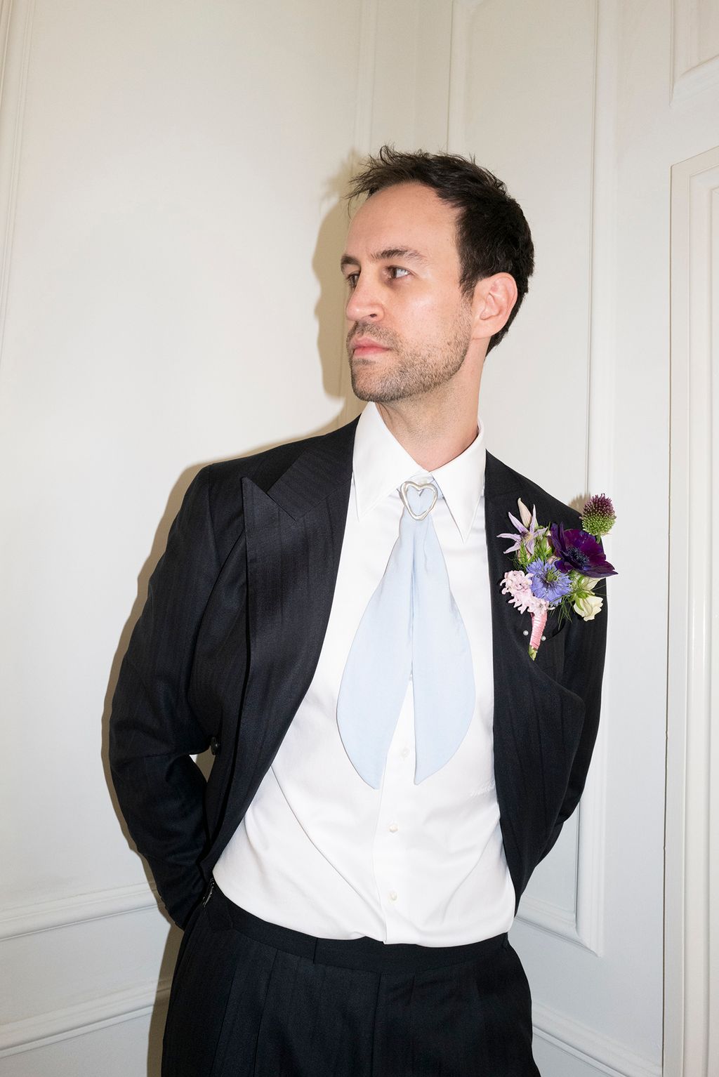 Image may contain Blazer Clothing Coat Formal Wear Jacket Suit Tuxedo Accessories Tie Shirt Adult and Person