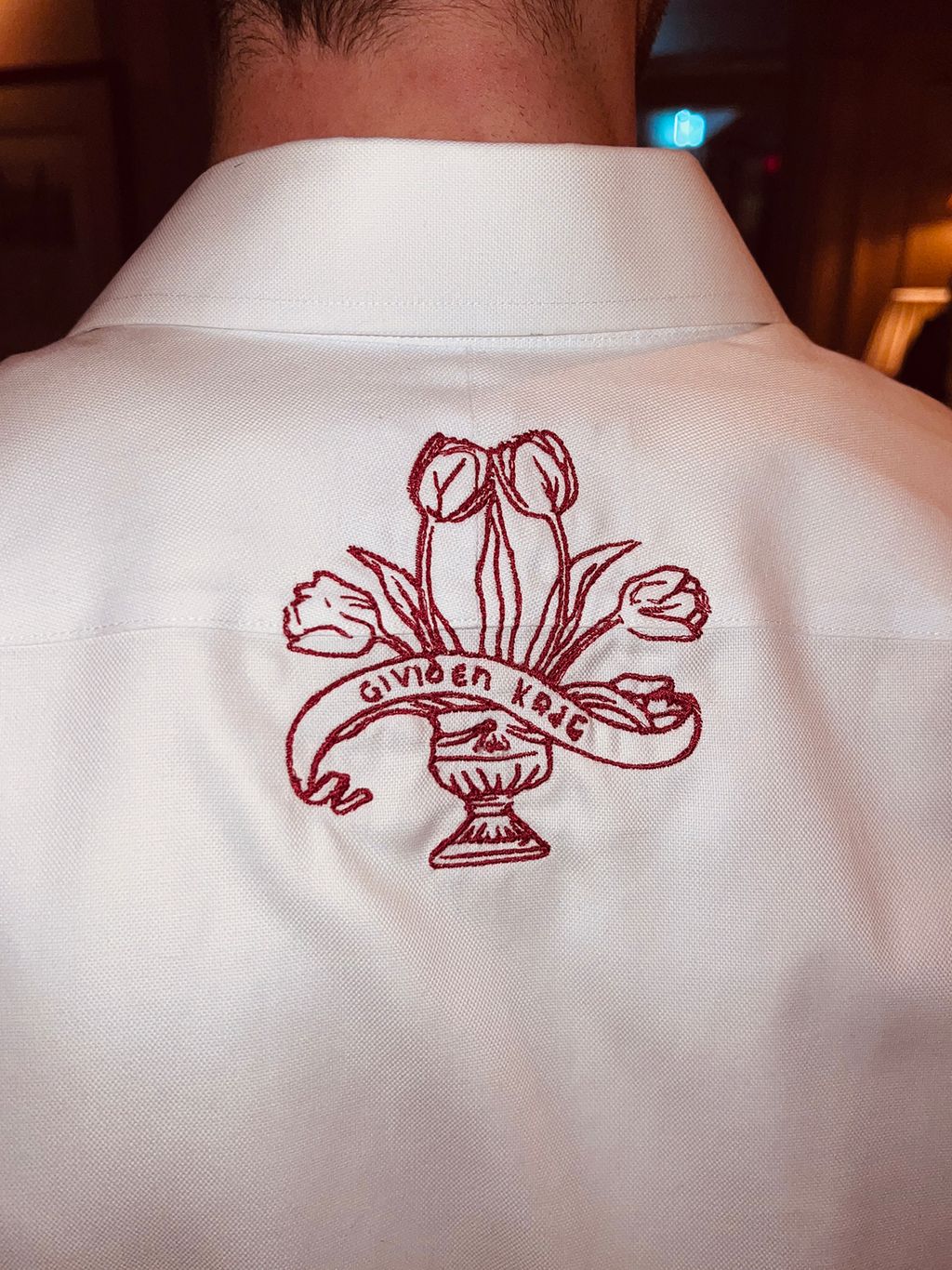 Image may contain Clothing Coat Pattern Embroidery Adult and Person